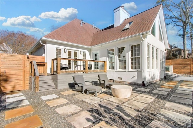 rear view of house with a patio area and a wooden deck