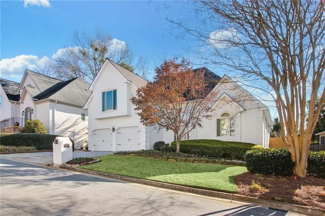 view of front of house featuring a front yard and a garage