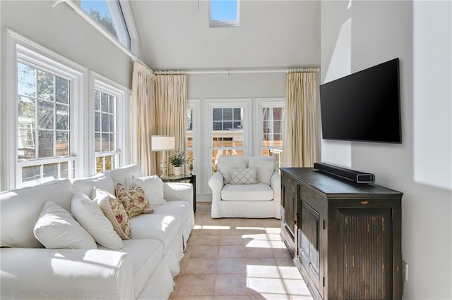 living room with lofted ceiling and light tile patterned flooring