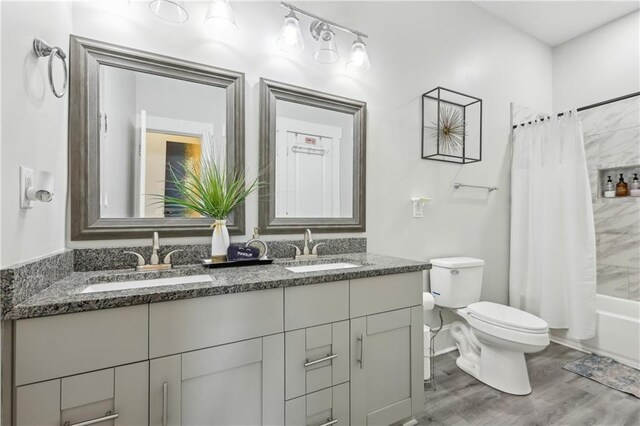906 Sims St SW, Atlanta, GA 30603 - bathroom featuring double vanity, toilet, wood finished floors, and a sink