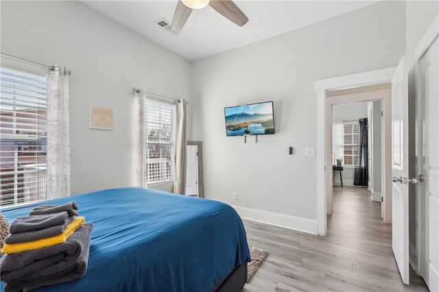 906 Sims St SW, Atlanta, GA 30603 - bedroom featuring light wood-type flooring, visible vents, baseboards, and a ceiling fan