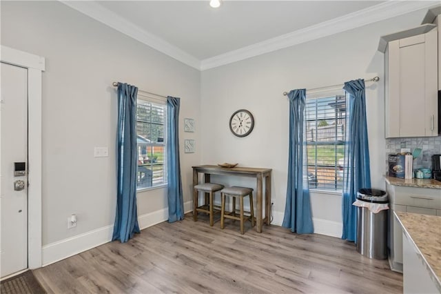 906 Sims St SW, Atlanta, GA 30603 - dining room featuring crown molding, baseboards, and light wood-type flooring