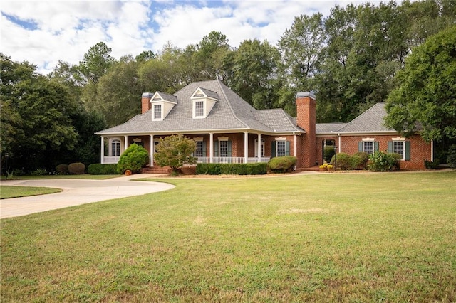 cape cod-style house with a porch and a front yard