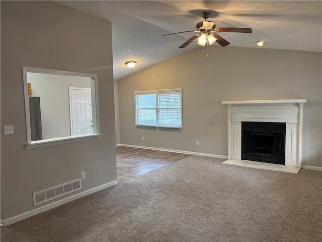 unfurnished living room featuring ceiling fan, carpet floors, a textured ceiling, and lofted ceiling