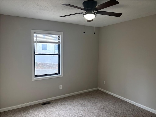 carpeted empty room featuring a textured ceiling and ceiling fan