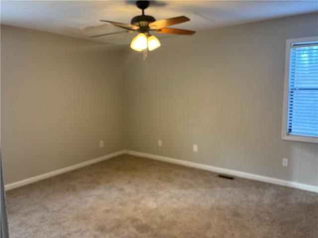 carpeted empty room featuring ceiling fan