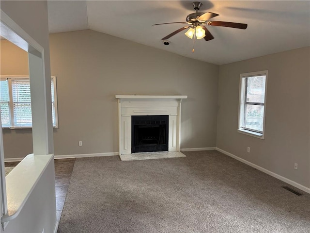 unfurnished living room with vaulted ceiling, ceiling fan, and carpet flooring