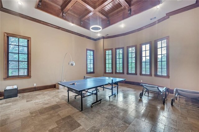 home theater with baseboards, dark colored carpet, visible vents, and crown molding