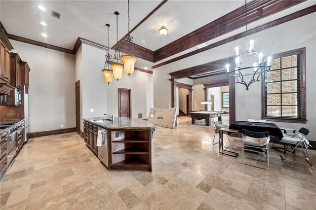 kitchen with a breakfast bar area, brown cabinetry, a sink, an island with sink, and built in appliances