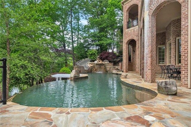 outdoor pool with a patio area