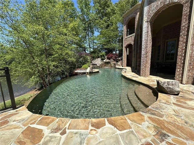 outdoor pool featuring a patio