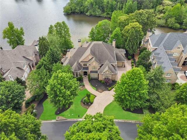 drone / aerial view with a water view and a residential view