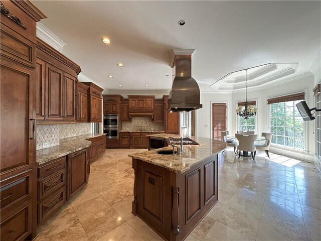 dining area featuring a wainscoted wall, light wood-style flooring, ornamental molding, french doors, and a notable chandelier