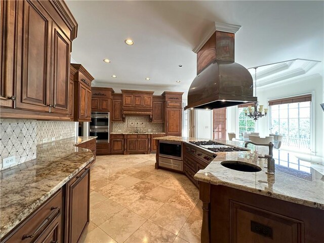 dining space with a chandelier, baseboards, a raised ceiling, and a healthy amount of sunlight