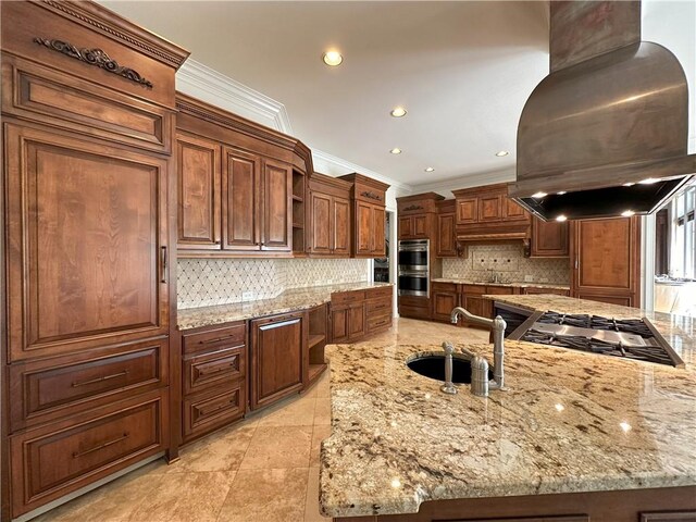 kitchen with a peninsula, island exhaust hood, built in microwave, stainless steel gas cooktop, and a sink