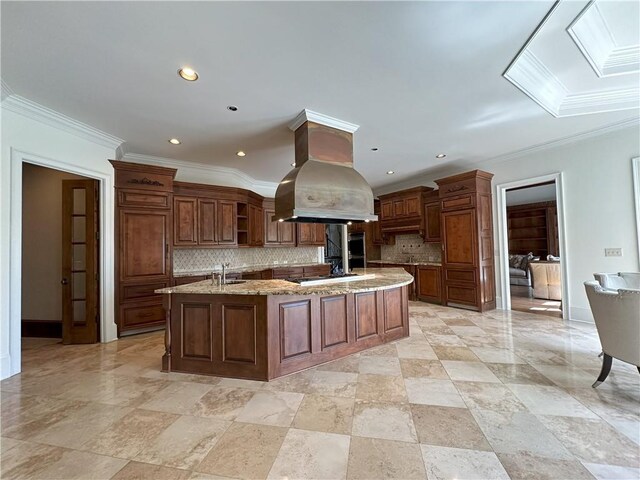 kitchen featuring crown molding, island exhaust hood, stainless steel appliances, a sink, and light stone countertops