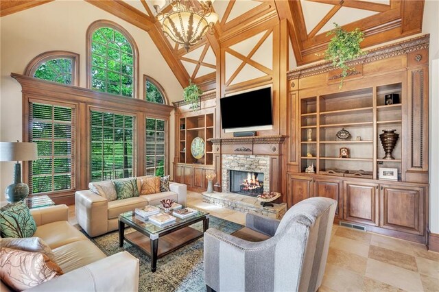 living area with a chandelier, coffered ceiling, wood finished floors, and decorative columns