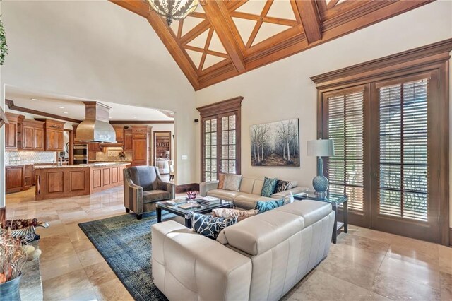 living room featuring coffered ceiling, beamed ceiling, and wood finished floors