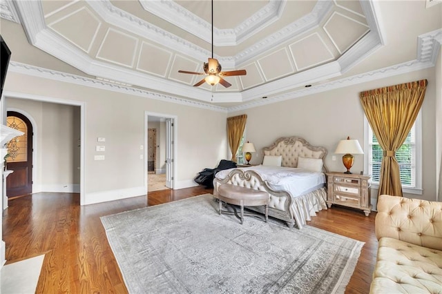 bedroom featuring crown molding, baseboards, coffered ceiling, and wood finished floors