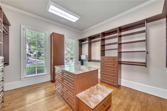 full bath with double vanity, baseboards, ornamental molding, a shower stall, and a sink