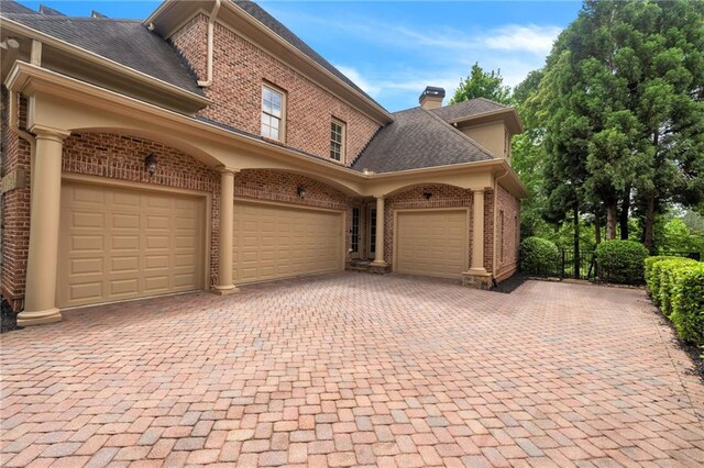 garage with decorative driveway