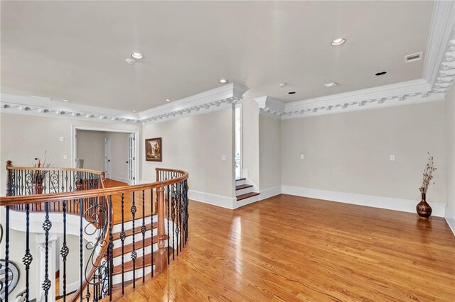 sitting room featuring light wood finished floors, baseboards, ornamental molding, and ceiling fan