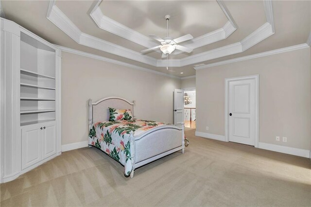 bedroom featuring light carpet, visible vents, baseboards, ornamental molding, and a raised ceiling