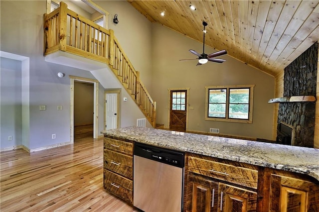 kitchen with wood ceiling, high vaulted ceiling, light stone countertops, stainless steel dishwasher, and light wood-type flooring