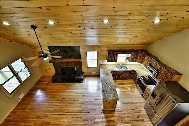 interior space with wood ceiling, plenty of natural light, vaulted ceiling, and light wood-type flooring