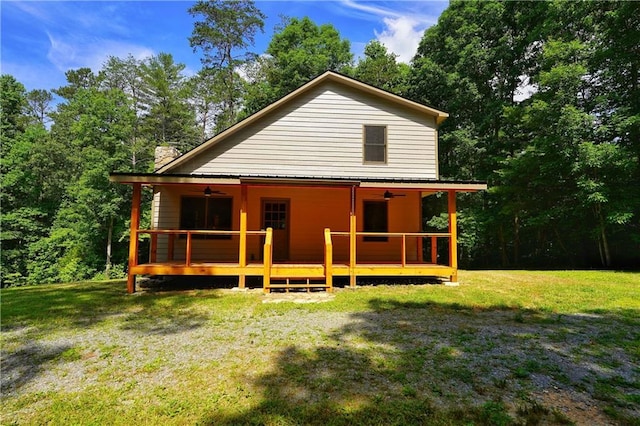 back of house featuring a wooden deck, a yard, and ceiling fan