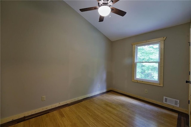 empty room featuring lofted ceiling, ceiling fan, and light wood-type flooring