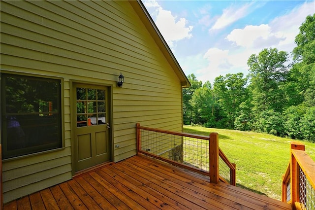 wooden terrace featuring a yard