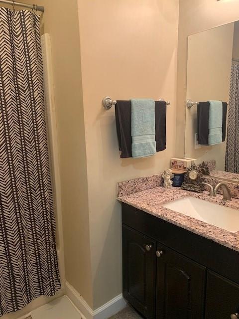 bathroom featuring vanity and a shower with shower curtain