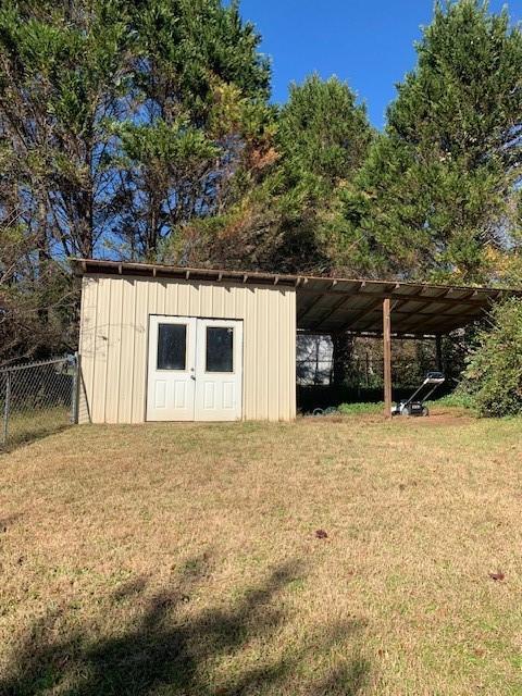 view of outdoor structure with a yard