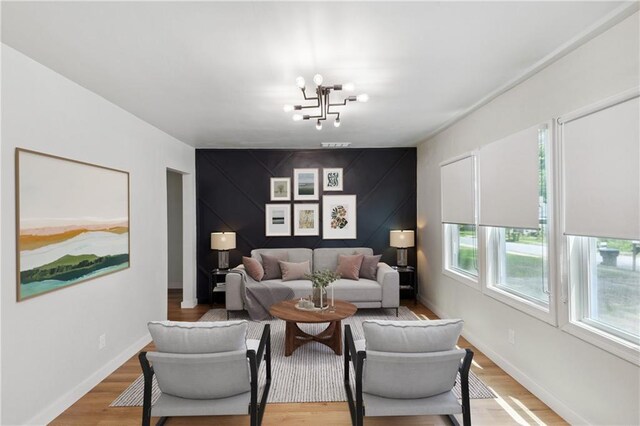 living room featuring hardwood / wood-style floors and a notable chandelier