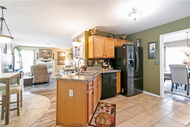 kitchen featuring a textured ceiling, black dishwasher, a sink, open floor plan, and fridge with ice dispenser