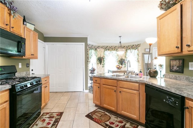 kitchen featuring a peninsula, a sink, black appliances, light countertops, and ornamental molding