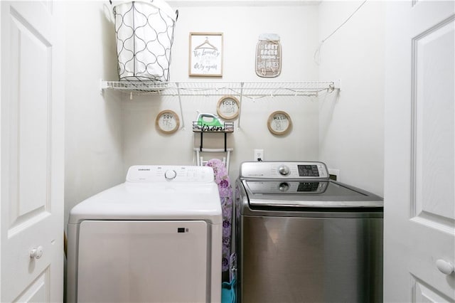 clothes washing area featuring washing machine and clothes dryer and laundry area