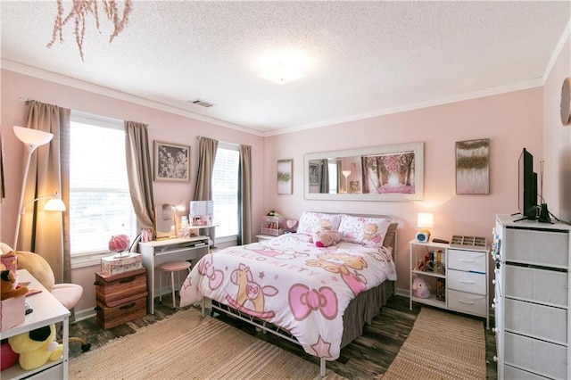 bedroom featuring ornamental molding, light wood finished floors, a tray ceiling, and visible vents