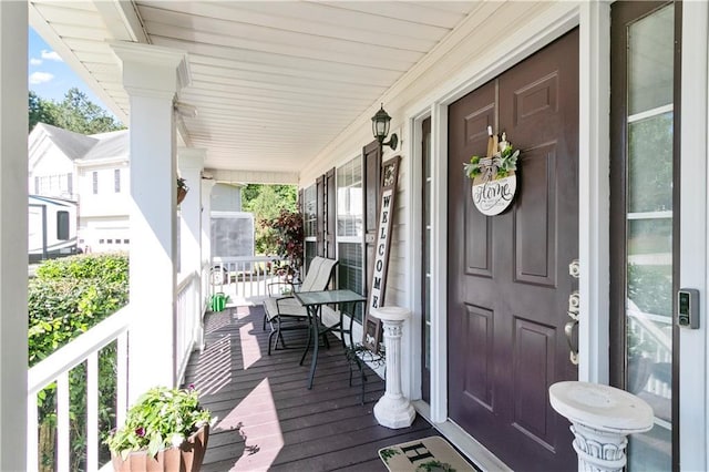 wooden terrace featuring covered porch