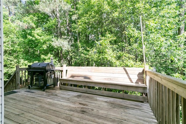 wooden terrace with a grill