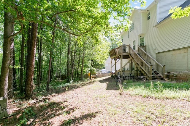 view of yard featuring fence and stairs