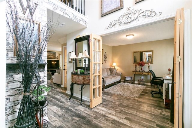 bedroom featuring a raised ceiling, ornamental molding, and wood finished floors