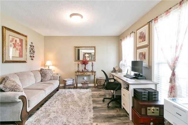 office featuring a textured ceiling, baseboards, and dark wood finished floors