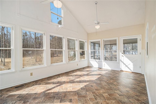 unfurnished sunroom with a ceiling fan, lofted ceiling, a healthy amount of sunlight, and visible vents