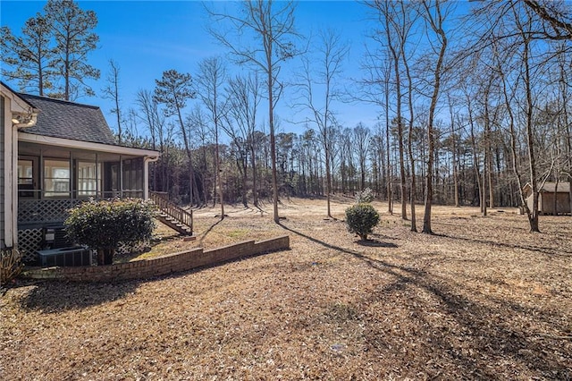 view of yard with stairway and a sunroom