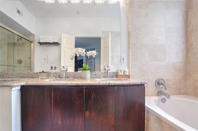 200 Renaissance Pkwy NE Unit 219, Atlanta, GA 30308 - bathroom with a garden tub, double vanity, and a shower stall