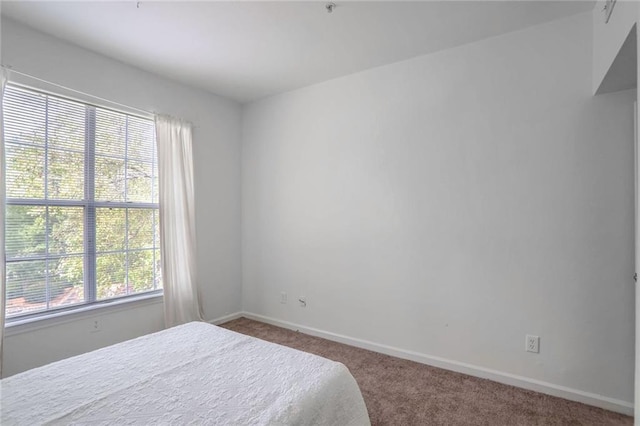 200 Renaissance Pkwy NE Unit 219, Atlanta, GA 30308 - carpeted bedroom featuring baseboards