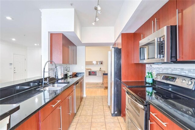 200 Renaissance Pkwy NE Unit 219, Atlanta, GA 30308 - kitchen featuring stainless steel appliances, dark stone countertops, tasteful backsplash, light tile patterned floors, and recessed lighting