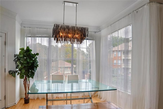200 Renaissance Pkwy NE Unit 219, Atlanta, GA 30308 - dining space with crown molding, plenty of natural light, wood finished floors, and a chandelier